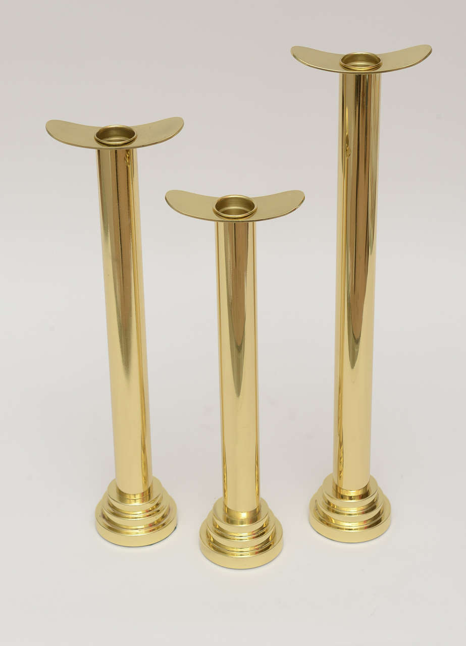 The stepped base and the t bar top give these stately candlesticks some flair.
They have a Karl Springer style to them. medium weight to all.
The sizes are : 18.5 