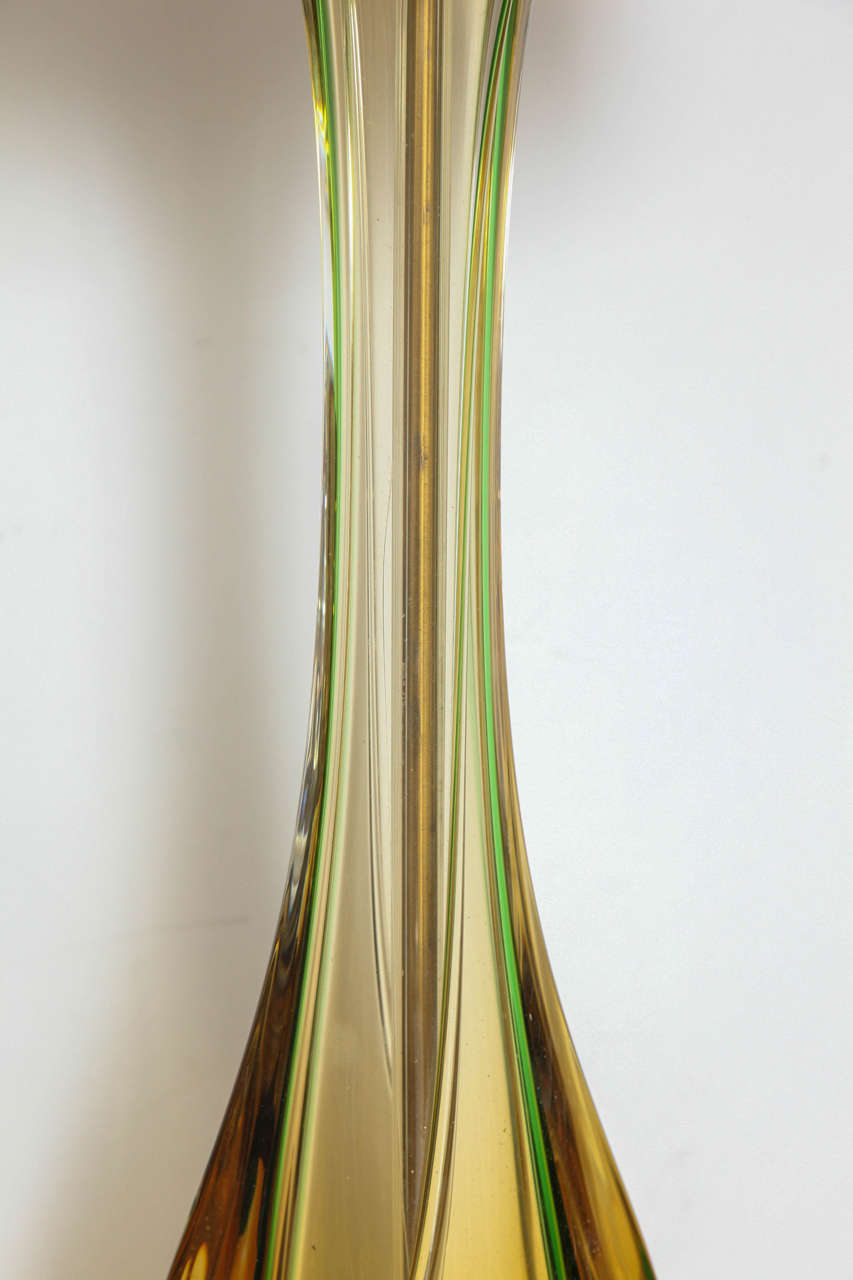 An elegant single tall Murano lamp of yellow and green glass cased in clear.