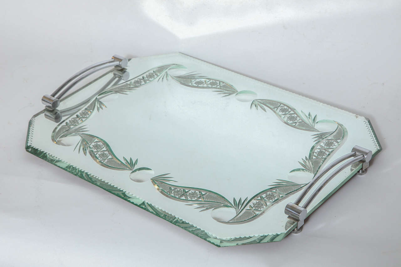 A stylish French mirrored vanity tray with nickel-plated handles and intricate beveling.