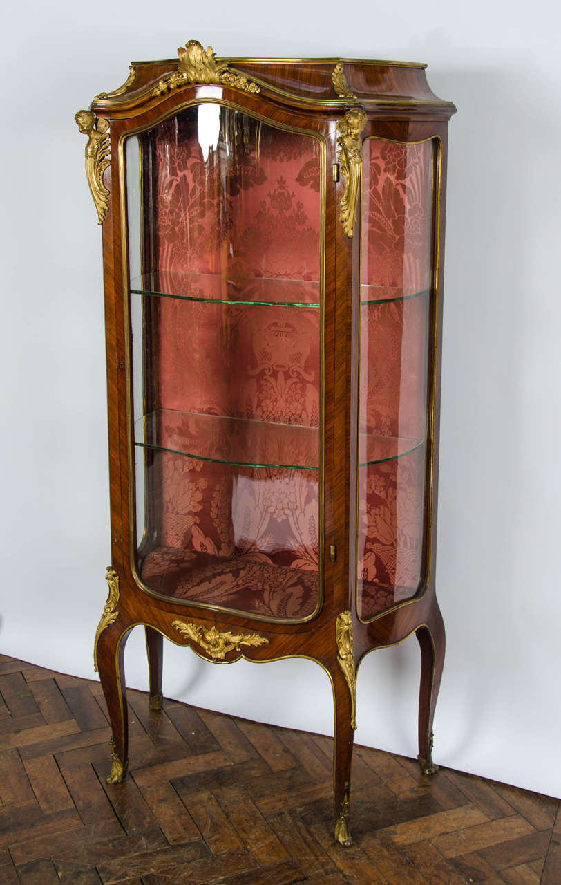 A fine quality French kingwood, marble topped vitrine having shaped glass to the front and sides. Beautiful ormolu mounts and raised on cabriole legs. The the manner of 'Linke.'.