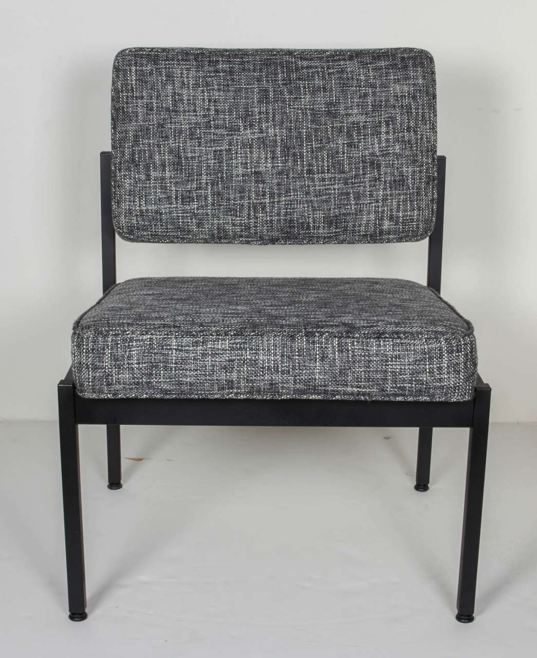 Mid-century modern industrial style chairs with streamline design and floating seat and back cushions. Fine example of utilitarian furniture, great as office chairs or easy chairs.  Satin black enameled metal frame is complimented by newly