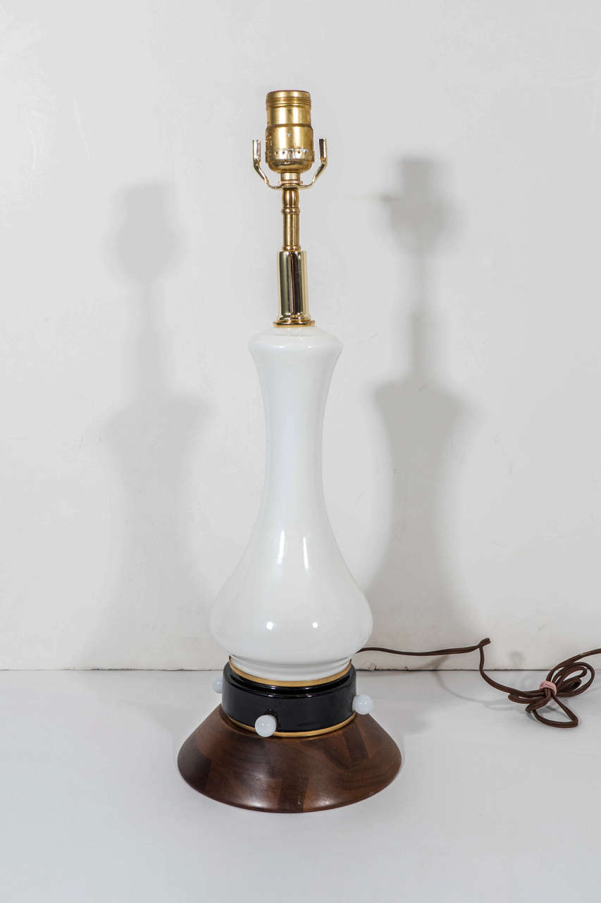 A pair of vintage Italian lamps, baluster form in white opaline Murano glass, on walnut bases with black lacquered band. Wiring and sockets to US standard, each requires one Edison base bulb. Excellent condition with little age appropriate wear.