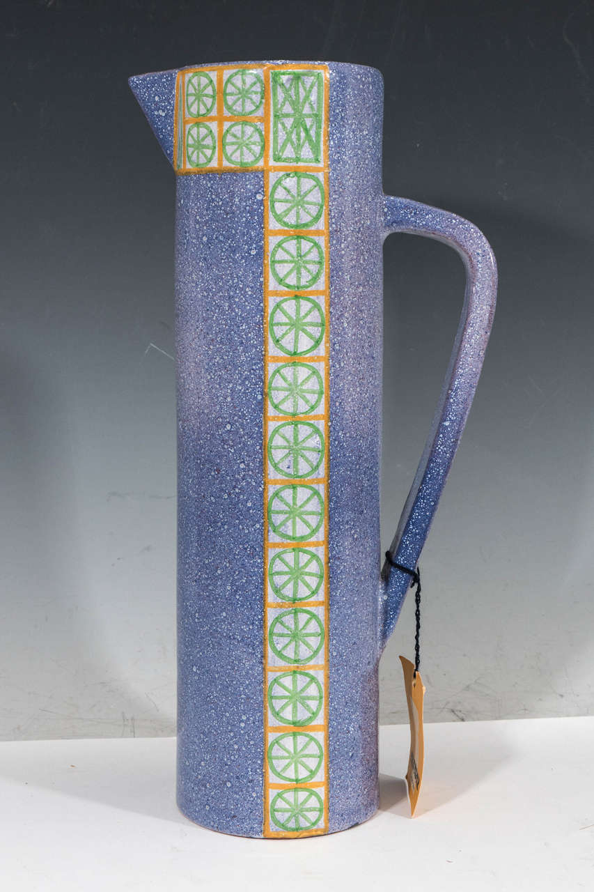 A vintage glazed and hand-painted ceramic pitcher, produced circa 1960s-1970s by Alfaraz workshop of Madrid, Spain, under the direction of ceramic artist Miguel Durán-Loriga. In addition to the maker's mark stamped to the bottom, is the original