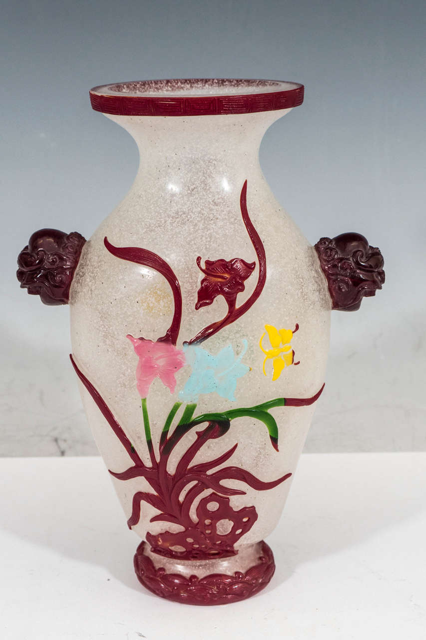 A Chinese cut-glass Peking vase, produced circa 1890's, within the later part of the Qing dynasty period (1644-1912), with stylized globe handles and decorative banding to the lip and base, the body decorated with naturalistic cascading floral
