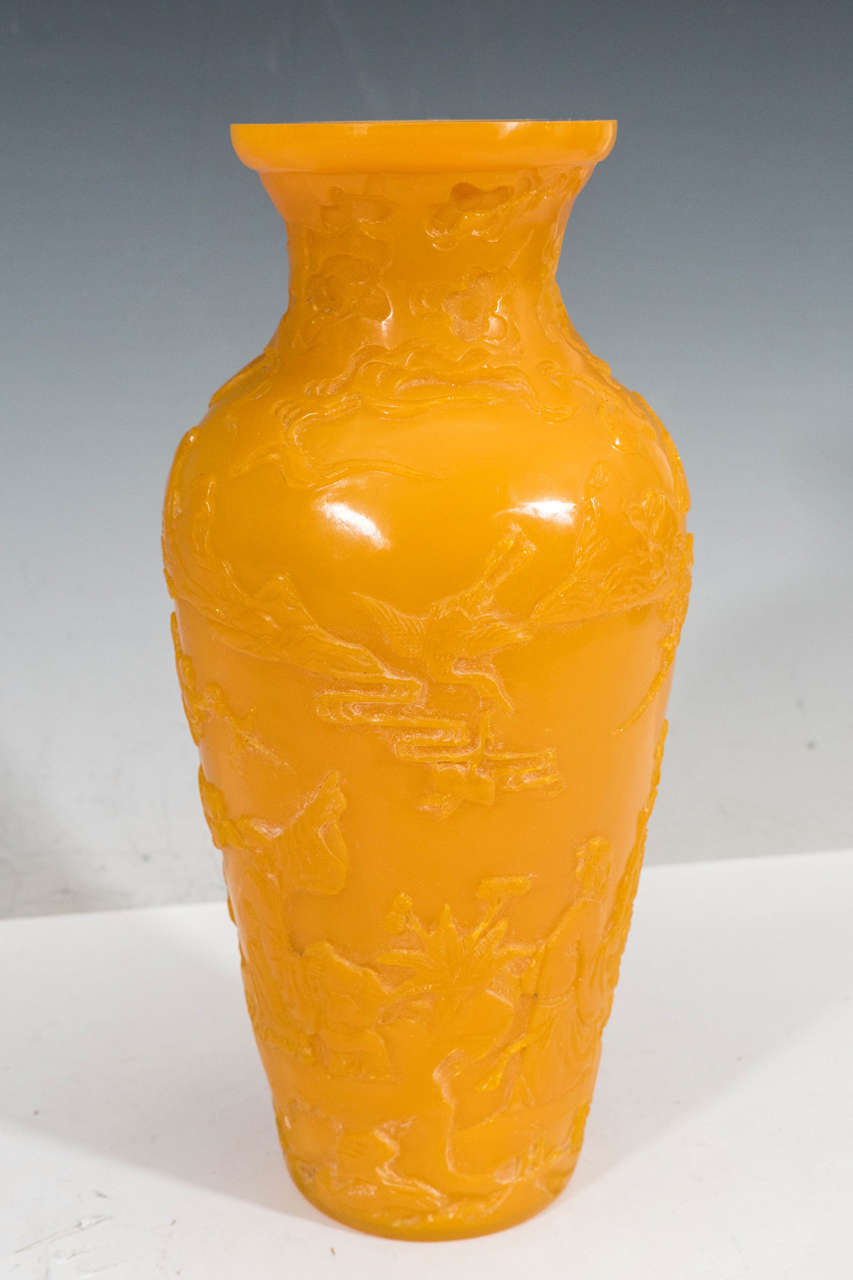 A Chinese cut-glass, classically formed Peking vase, produced in solid yellow, the body decorated with highly detailed reliefs of floral motifs and figures, circa 1900s. Good antique condition with some age appropriate wear.