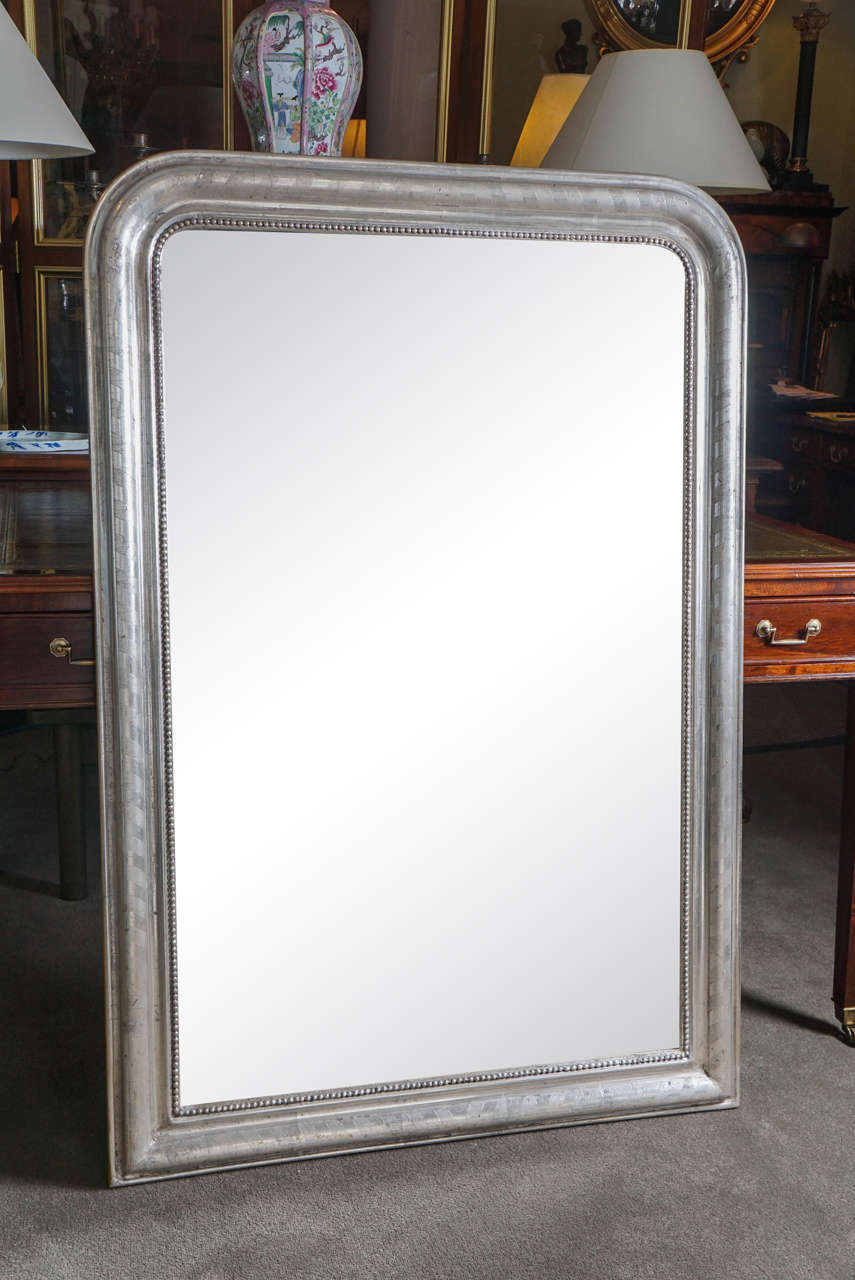 French silver gilt mirror with decorative incised moulding.