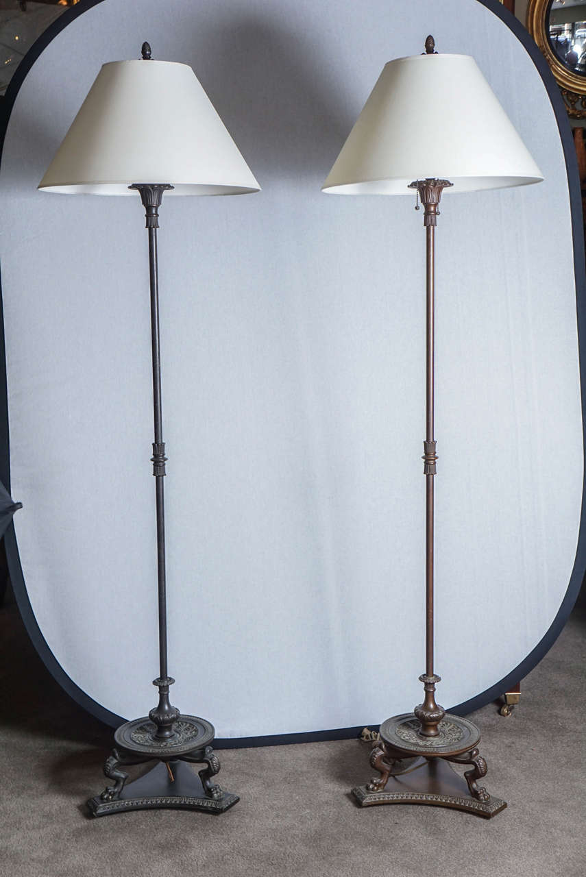 Pair of bronze floor lamp attributed Caldwell. The casting is identical but the patina do not match. 
shades not included.