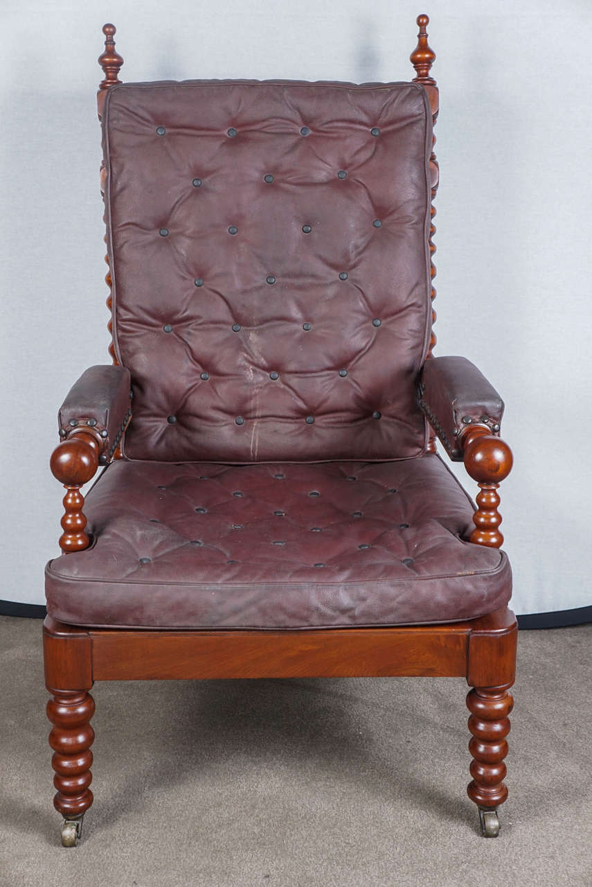 English mahogany bobbin armchair with original leather cushions.