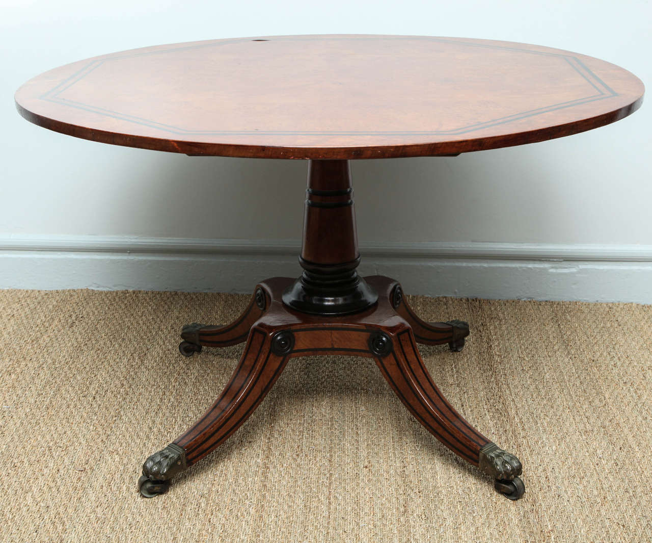 Highly figured ebony inlaid burr oak circular breakfast table in the manner (and attributable to) George Bullock, the top with book matched veneer and two stripes of ebony octagonal banding, the base of typical Egyptian  form with ebonized grooves