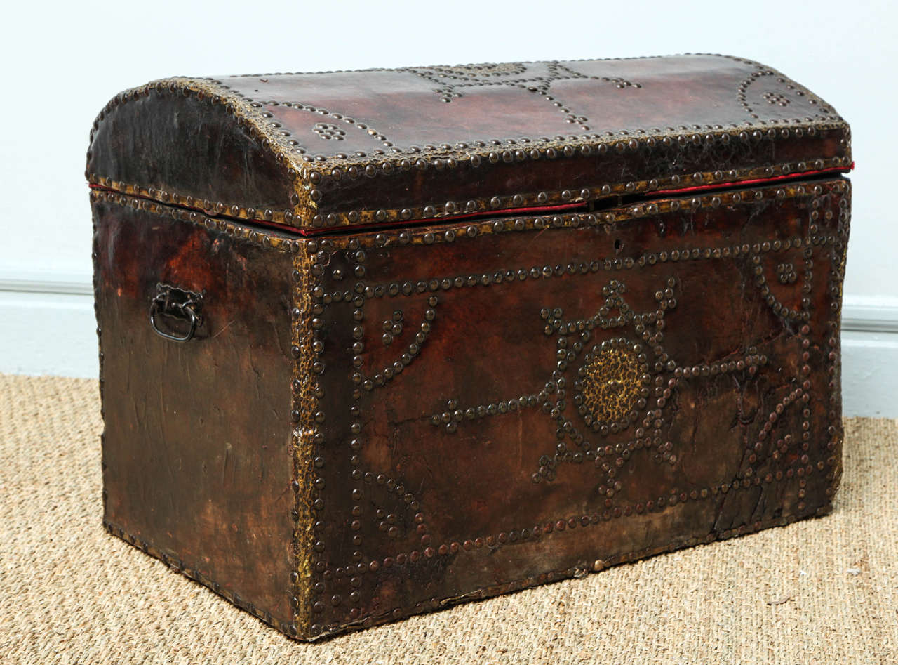 19th century brass trimmed studded leather trunk with slightly domed top, well patinated tobacco leather, useful scale and original hardware.