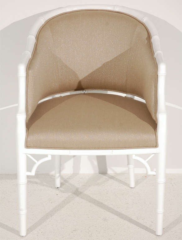 A charming set of four white lacquered faux bamboo tub chairs by Monteverdi-Young. Newly reupholstered in a taupe fabric with a hint of lurex for some sparkle.