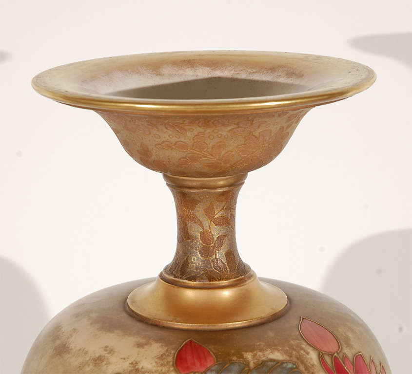A striking, tall floral motif vase with raised gilding details by Samuel Wilson for Doulton Burslem.