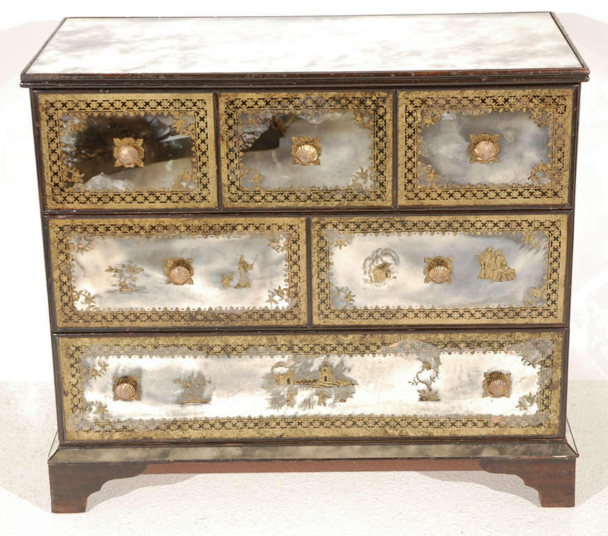 Charming petite chest of drawers in verre eglomise antique mirror featuring Chinese motifs with brass shell pulls by New Era Glass.