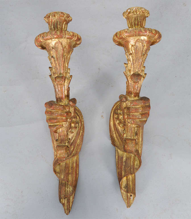 Pair of carved giltwood sconces, by Palladio, each a draped hand holding a torch.  Not electrified.