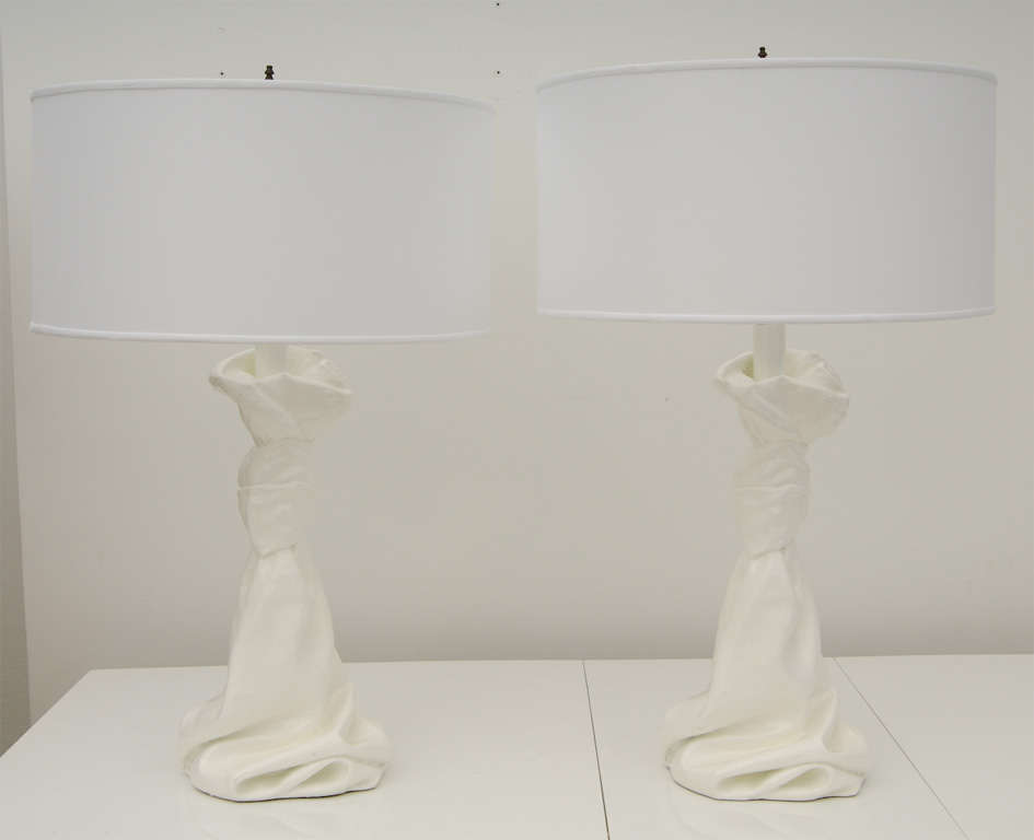Pair plaster lamps draped and knotted with custom drum shades. Finished in high gloss white yet in the style of John Dickensen. Sold as a pair and priced with custom shades.
Measurements: Height: To top of finial: 33, To top of socket: 24
        