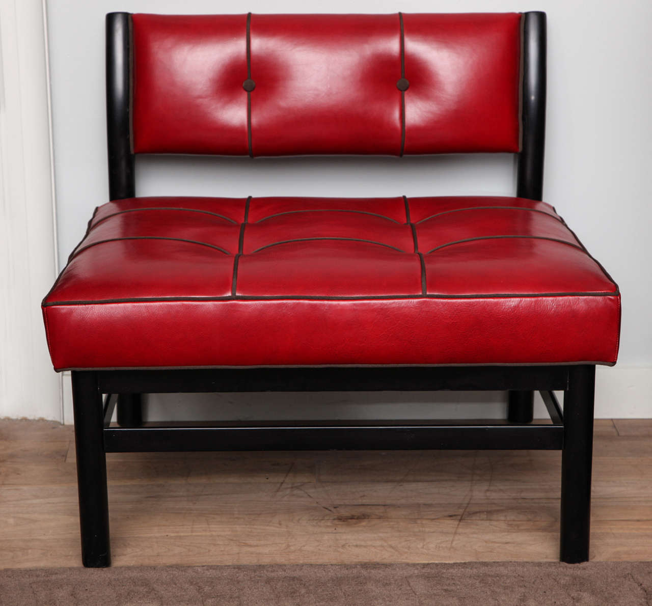 Ebonized slipper chair by Harvey Probber circa 1950 re-executed with a revised tufted back and seat cushion, red leather upholstery with espresso French grosgrain trim