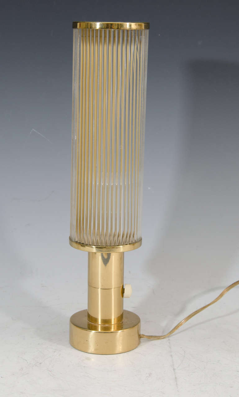 An Art Deco pair of column style brass lamps with undulated glass panel shades.

Good vintage condition with some age appropriate wear to brass finish.

Reduced from: $2,400