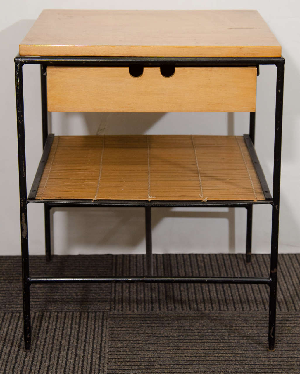 A vintage pair of Paul McCobb end or side tables with iron frames. Each with one wooden drawer and one shelf. 

In good vintage condition with age appropriate wear.

Reduced from: $4,800
