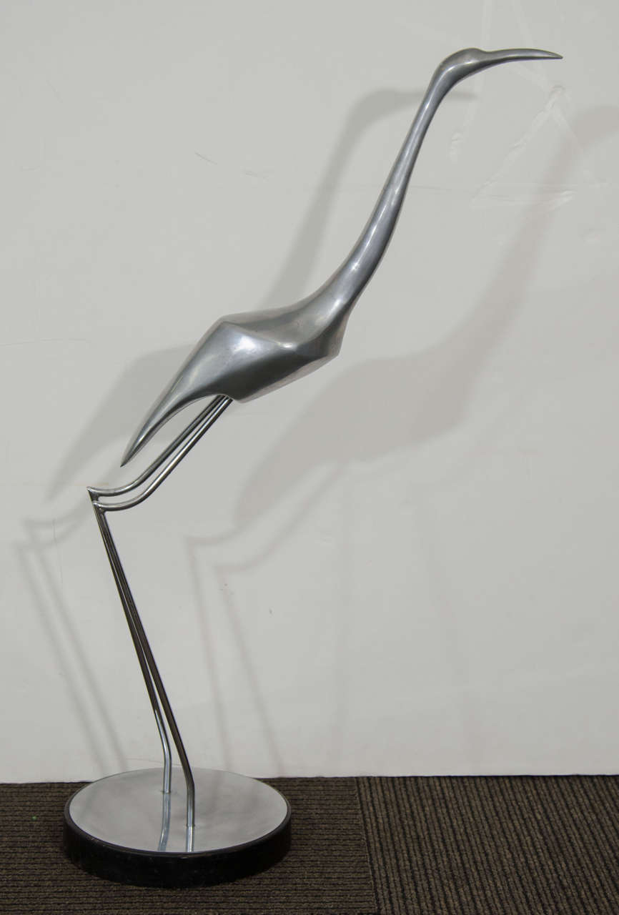 A vintage stainless steel sculpture of a standing crane bird on a round base signed, Curtis Jere 1978.

Good vintage condition with age appropriate wear.