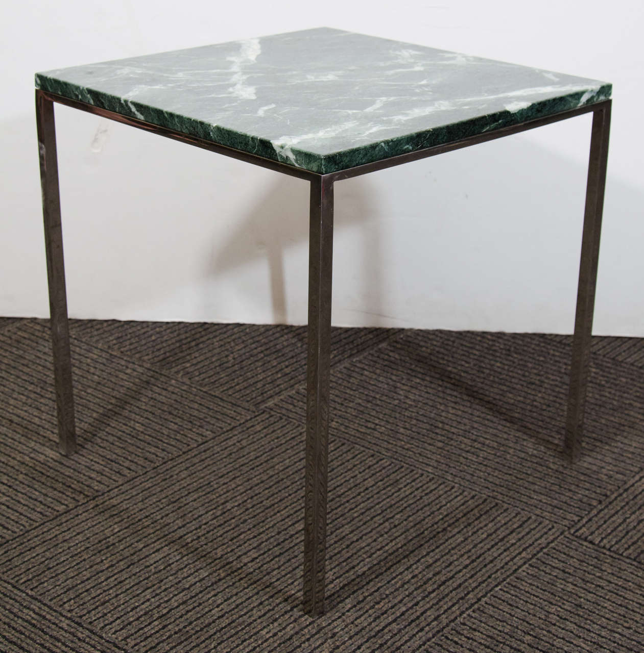 A mid century small square side table by Florence Knoll with a chrome base and a green marble top. This table was purchased from Chase Bank, and is signed Chase Bank on the underside of the marble. The chrome base is thinner under the marble than