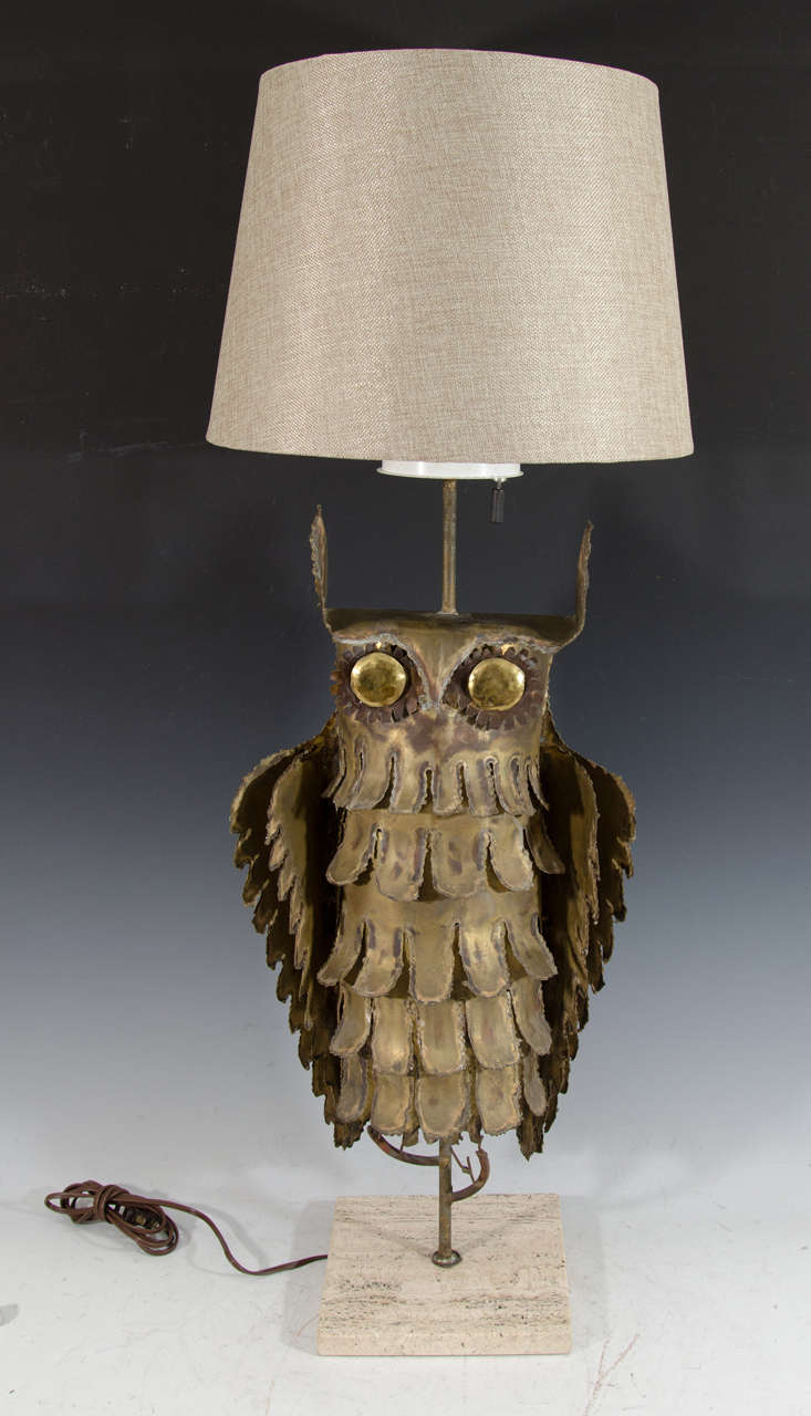 A Mid-Century Brutalist table lamp depicting an owl perched on a branch. The lamp sits on an 8