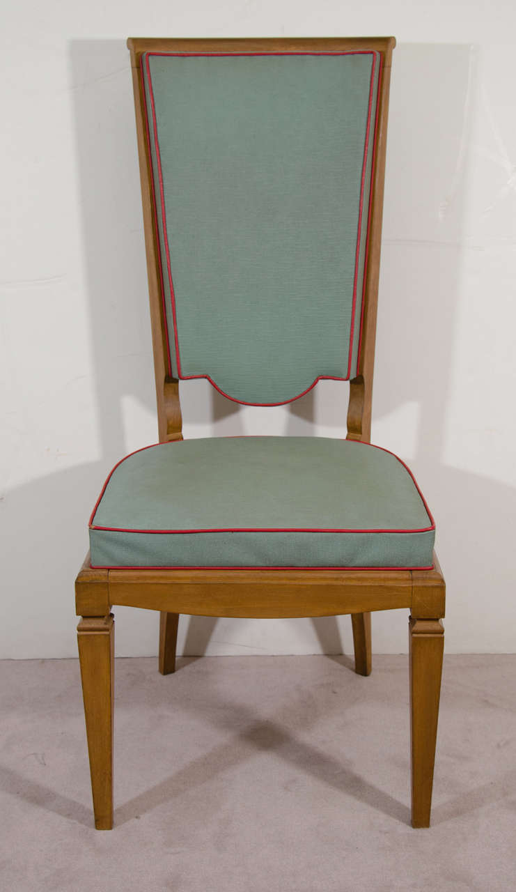 An Art Deco set of four wood dining room chairs with green and red trimmed leatherette upholstery in the style of Andre Arbus.

Good vintage condition with age appropriate wear.

Reduced from: $1,900