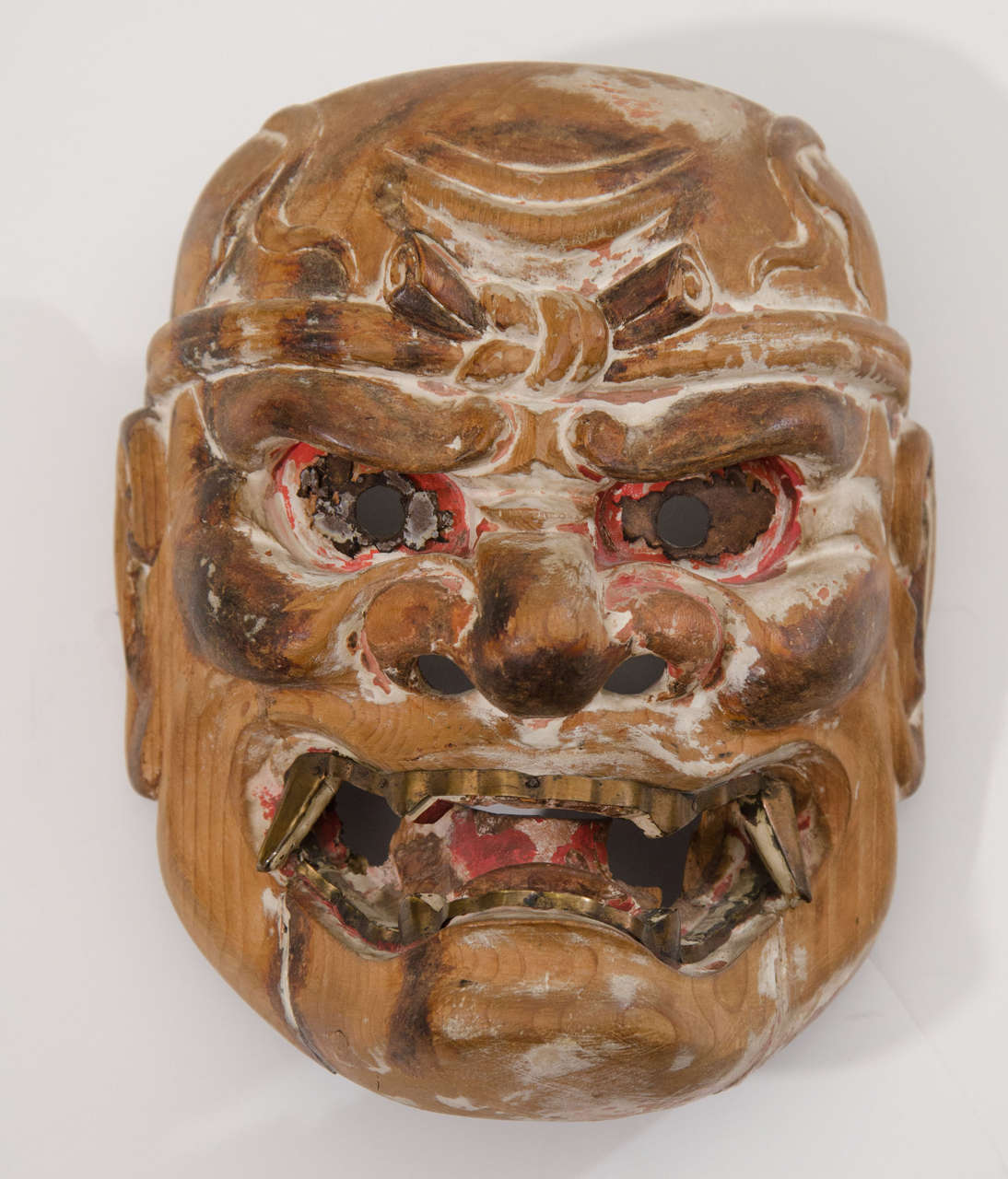 A powerful and rare Japanese Edo Period Kyogen mask of a Nio Guardian King; ferocious native deities often associated with the Naga Dragon Kings, who converted to Buddhism and now act as bodyguards for the Buddha.  The Edo period was the golden age