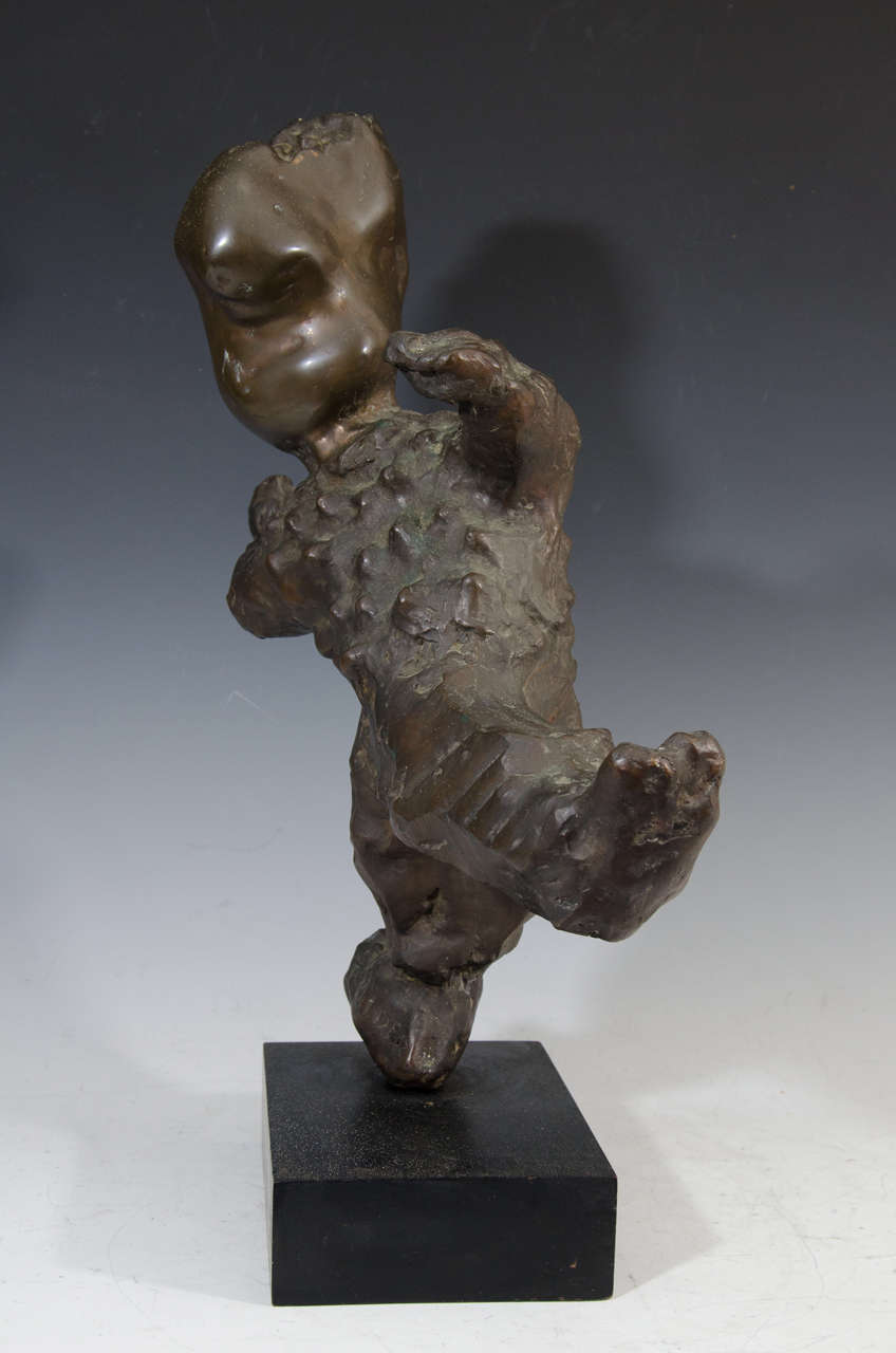 A 20th century bronze sculpture in abstract figurative form. In good vintage condition consistent with age and use. The sculpture is signed near the bottom.
