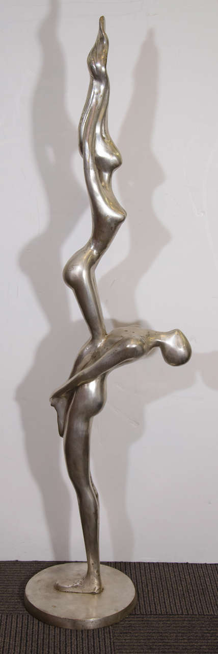 A vintage, monumental, unsigned, silver over bronze figural statue of a nude man balancing a nude woman. In the style of  Ernest Trova.

Good vintage condition with age appropriate wear. Some pitting.

Reduced from: $4,800