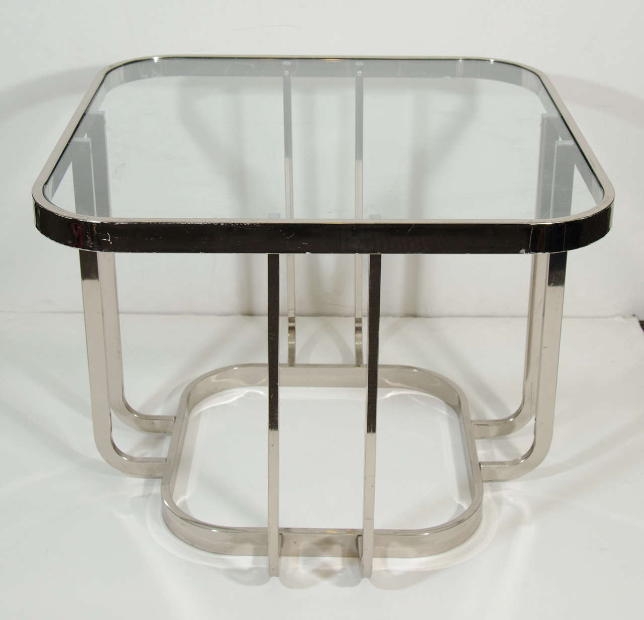 A mid century chrome pair of side or end tables with rounded corners and inset glass top.

Good vintage condition with minor scratches and loss to the chrome.

Reduced from: $1650