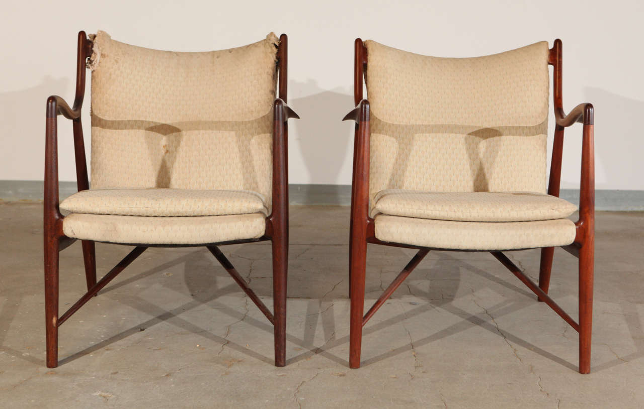 Pair of Finn Juhl by Niels Vodder NV 45 teak and fabric armchairs.