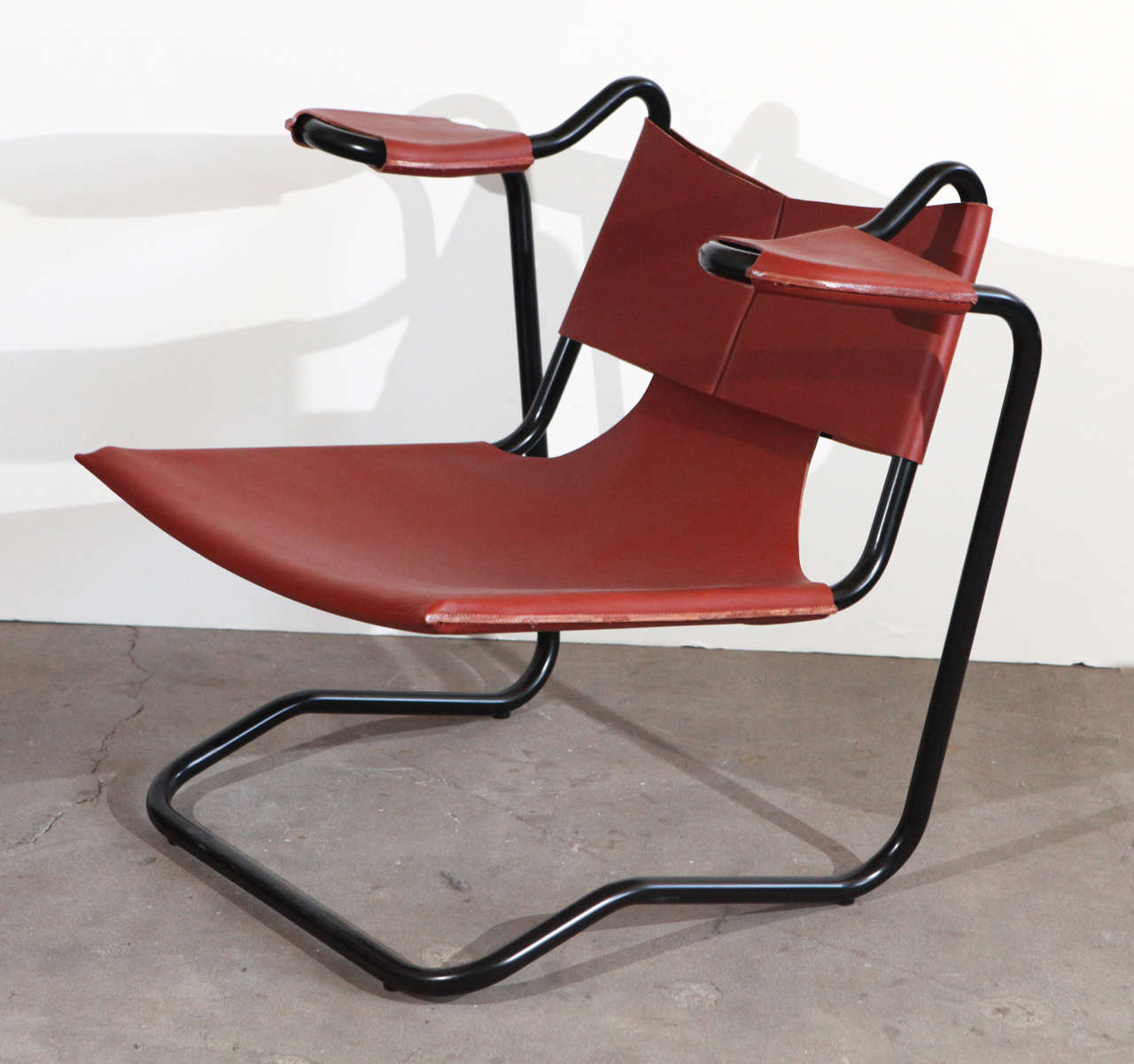 Dan Johnson sling chair in brown leather.