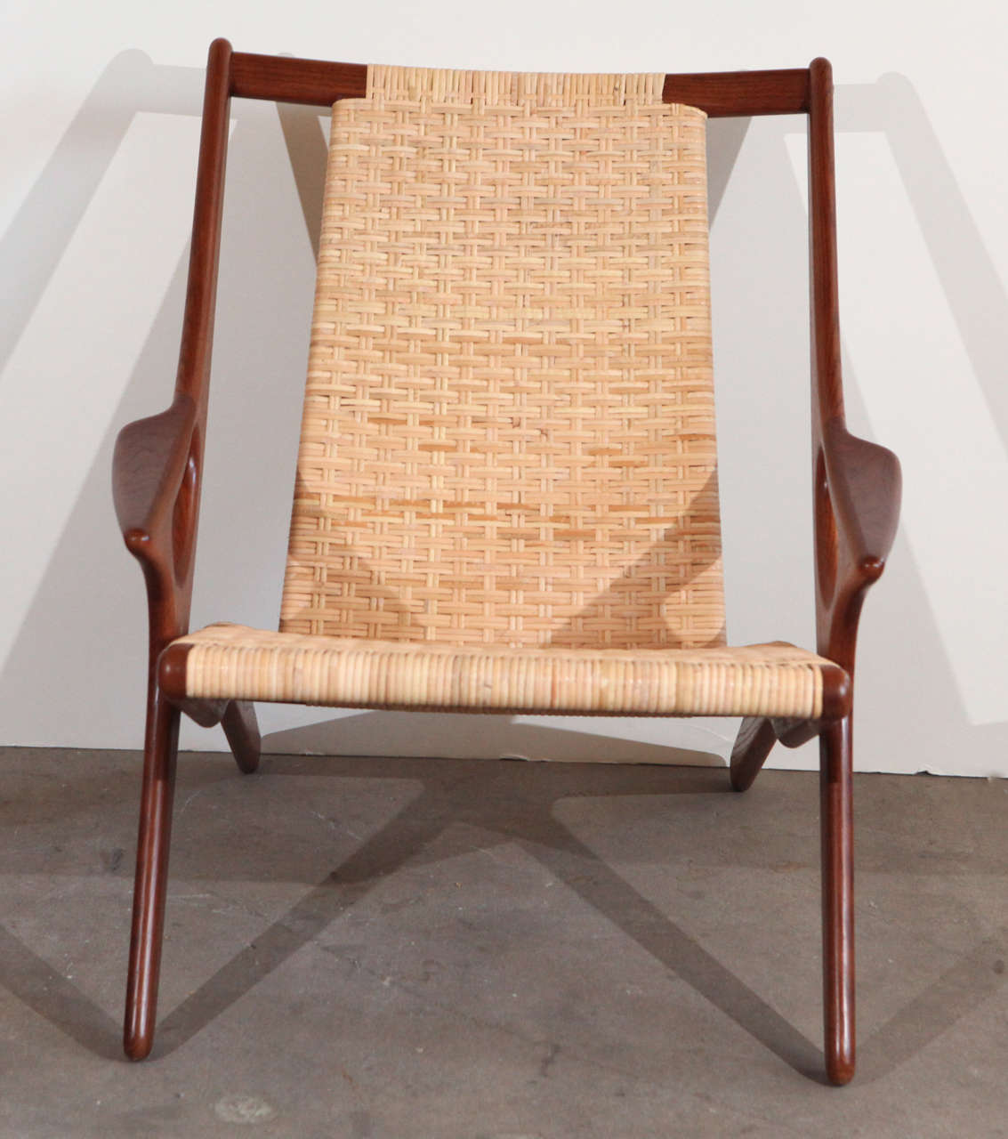 Laid-back armchair designed by Arne Hovman-Olsen in teak and wicker.