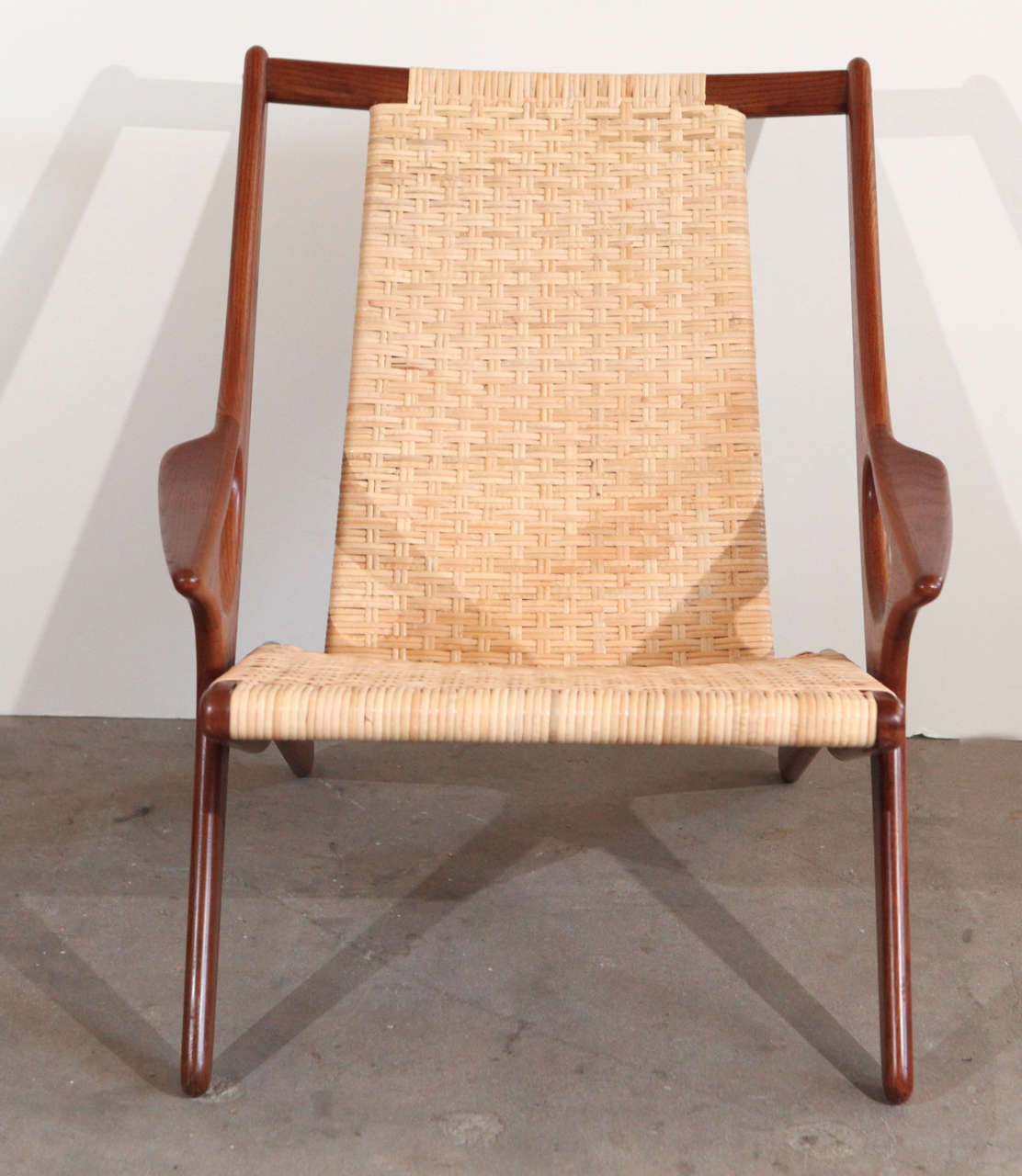 Laid-back armchair designed by Arne Hovmand-Olsen in teak and wicker.