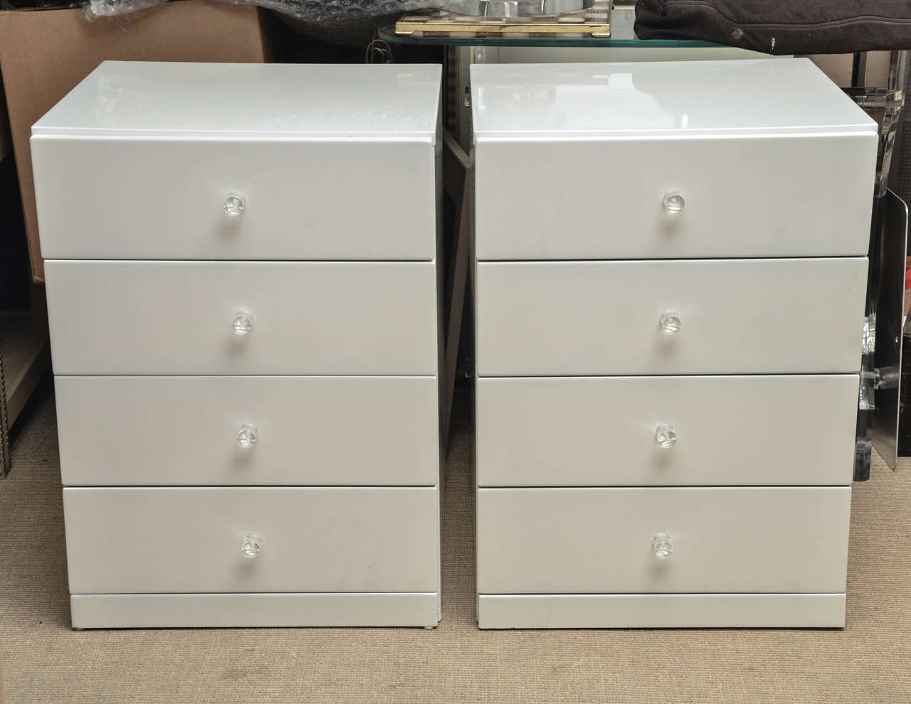 Pair of Mid-Century white lacquer four-drawer nightstands with Lucite drawer pulls.