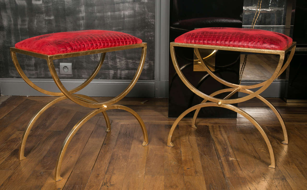 Pair of brass stools upholstered with red leather
