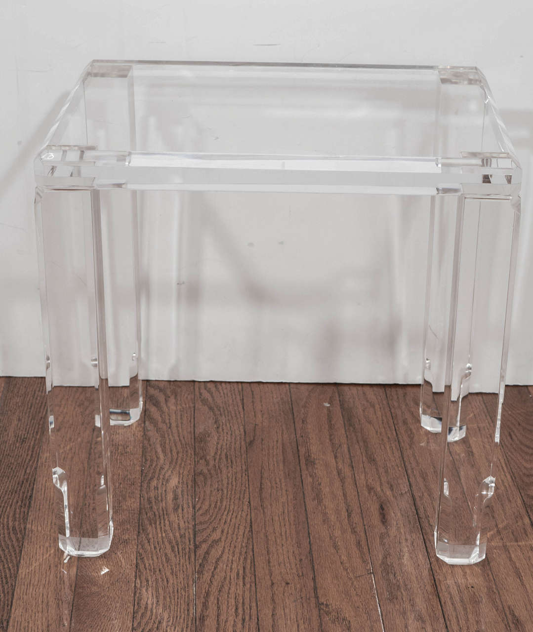 Pair of petite, lucite tables with beveled edge details.