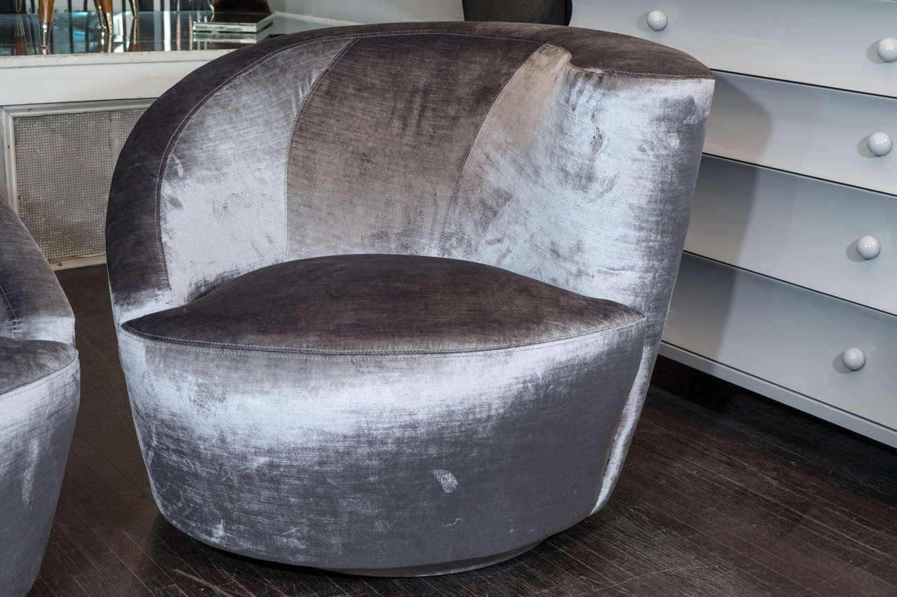 Pair of Vladimir Kagan designed nautilus swivel chairs reupholstered in grey velvet.