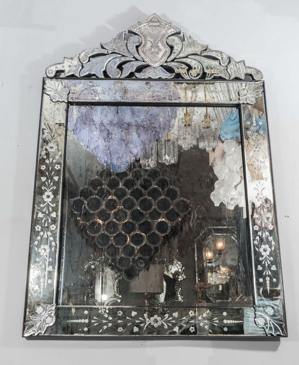 Vintage Venetian style mirror with an elaborated etched detail crown top. The mirror is antiqued with aged silvering finish.