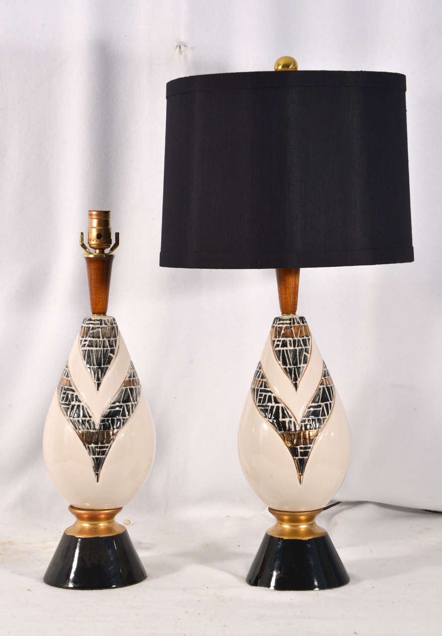 Mid-Century Modern table lamps, black and white, exceptional geometric design with gold accents, priced without lamp shades at the reduced price of $500. For the pair. Shades shown are 16