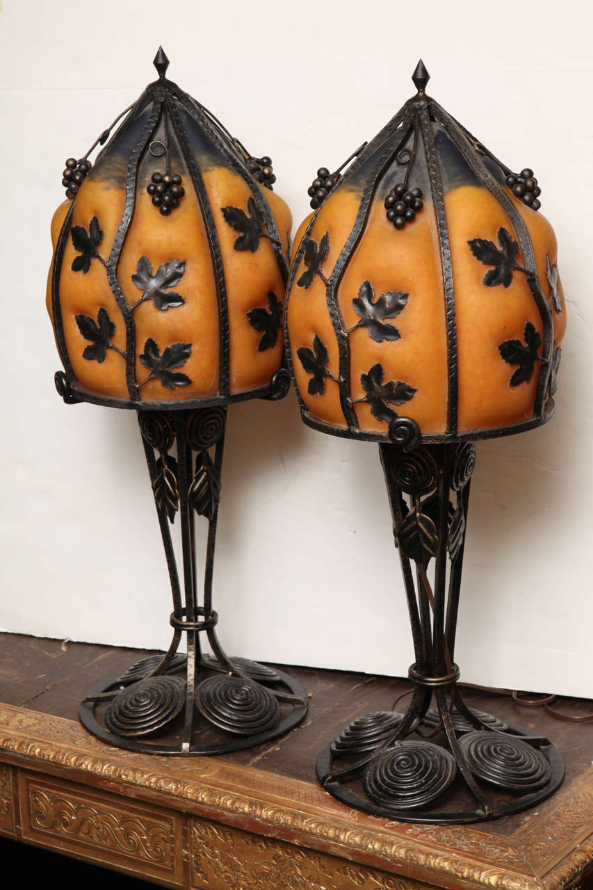 Pair of very unusual Art Deco style wrought iron and art glass table lamps.
Stock number: L28.