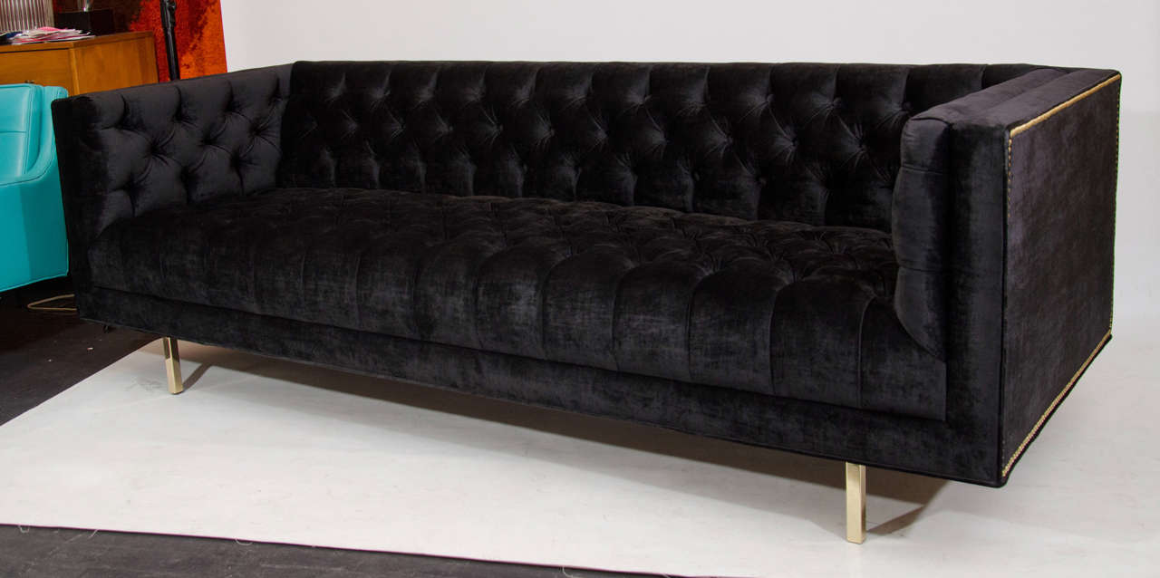 Beautiful and plush, deeply button tufted sofa in a black velvet, accented with brass nailheads and supported on brass legs. This is a custom design by Las Venus from our Ludlow Collection, licensed exclusively by and for Las Venus, in your size and