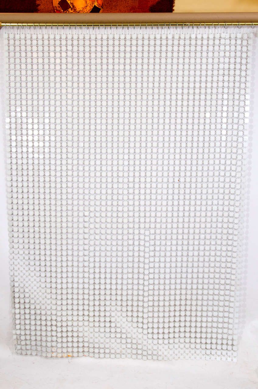 Beautiful white colored space curtain by Paco Rabanne. One side is white and the other side is a flat silver. The curtain is comprised of the same links that he used on his iconic mini dresses: plasticized metal discs joined by plastic gray colored