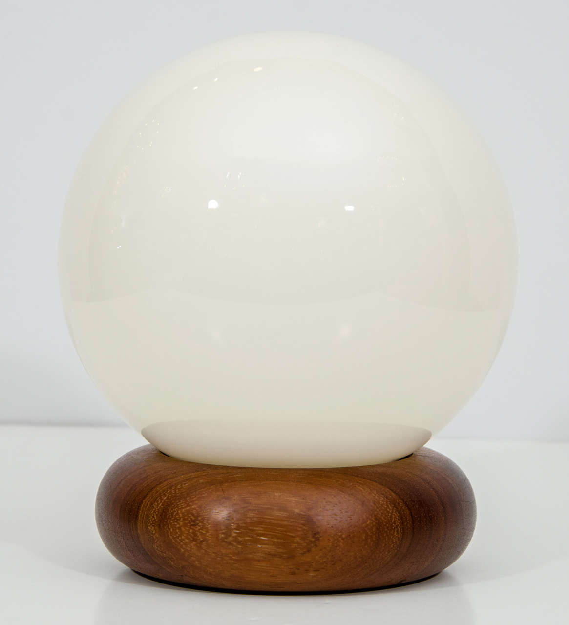 Charming pair of mod, Swedish accent lamps. Glass globes rest in contoured walnut bases. Please contact for location.