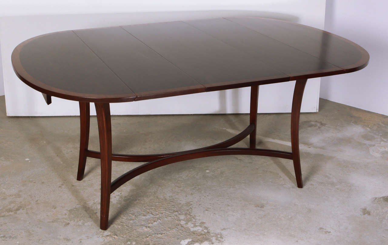 Elegant Tommi Parzinger dining table. Comes with two leaves. Measures 62.25