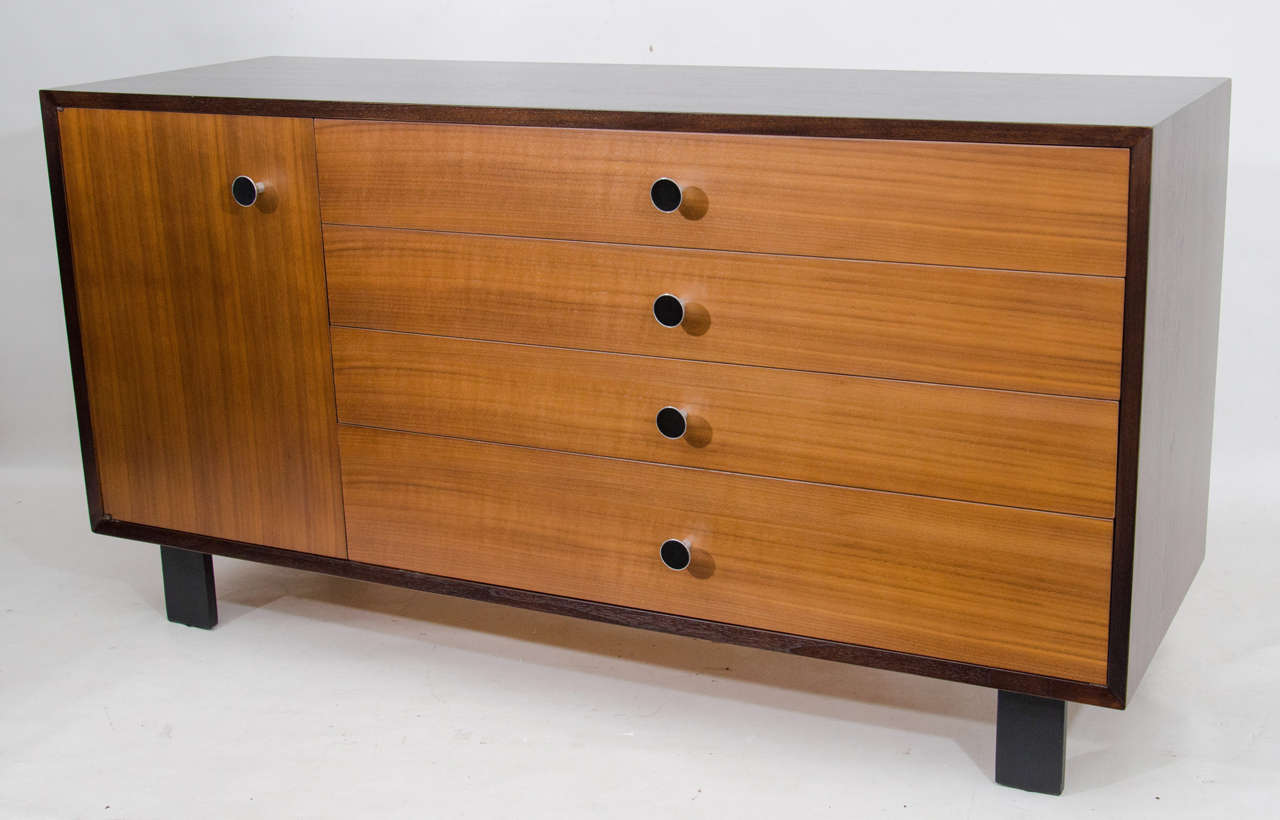 Very handsome dresser with cabinet by George Nelson. The case is lacquered in a deep espresso and the drawer fronts have a rich walnut veneer. The piece is accented with rare drawer pulls. Please contact for location.