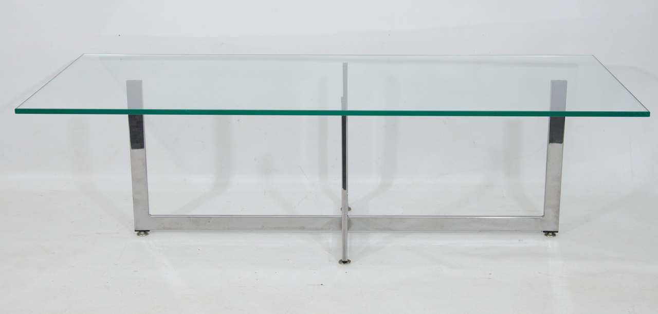 Beautiful glass top coffee table elegantly supported on four chrome points. Please contact for location.