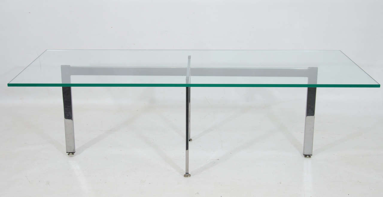 Clean and crisp design. Rectangular coffee table with a linear chrome base. Please contact for location.