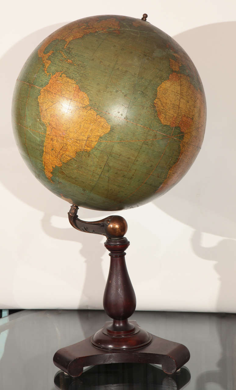 A large late 19th Century globe by C S Hammond, New York. Mounted on a substantial mahogany base topped with a copper ball and arm. There are some light flaws to the globe. There are age cracks and old touch ups to the the globe near China/Japan, by