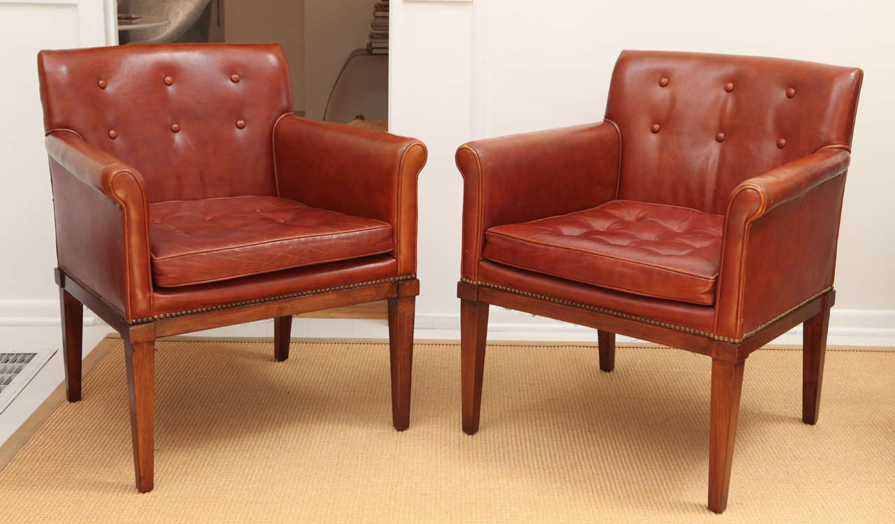 Brown Leather armchairs designed by Ralph Morse in Grand Rapids. Worn beautifully, the chairs are comfortable and a perfect size and scale for an occasional living room chair; Would be also amazing for an office or den/library